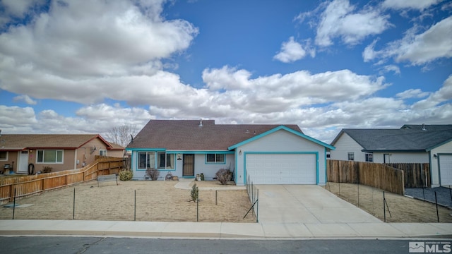 view of front of house with an attached garage, fence, and concrete driveway