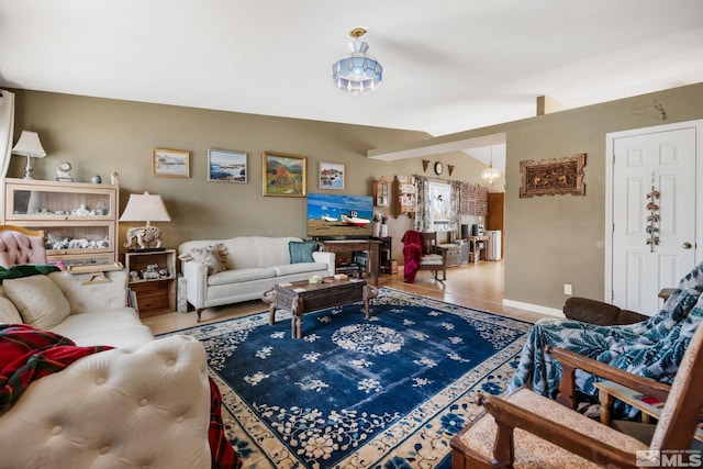 living area with an inviting chandelier and baseboards