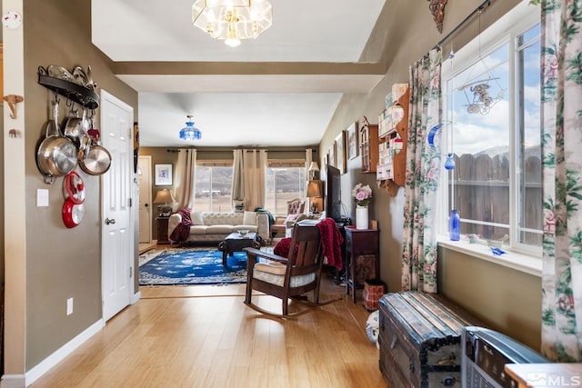 entrance foyer with baseboards, wood finished floors, and an inviting chandelier