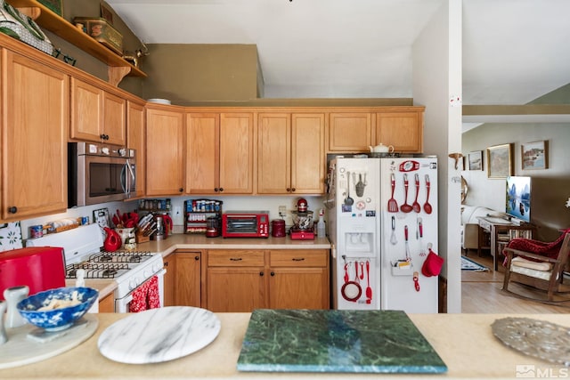 kitchen with white appliances, a toaster, and light countertops