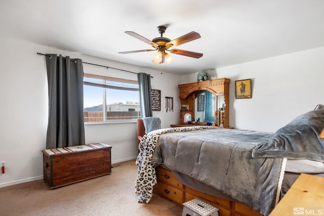 bedroom featuring carpet floors, baseboards, and a ceiling fan