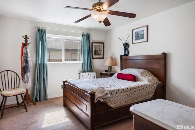 carpeted bedroom featuring baseboards and a ceiling fan