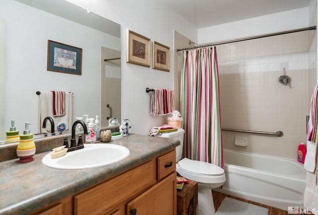 full bath with toilet, shower / tub combo with curtain, and vanity