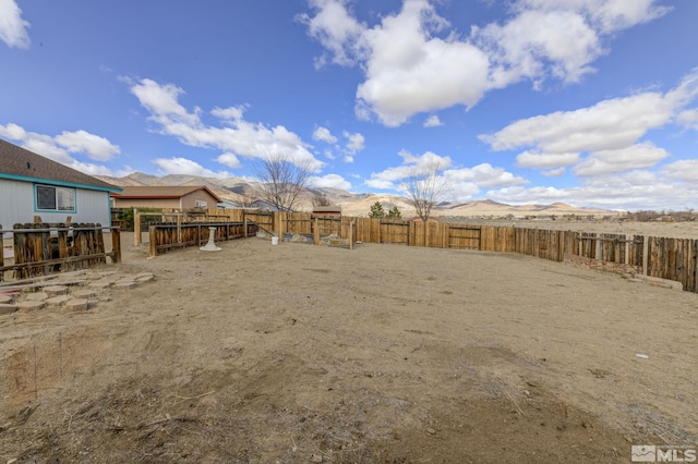 view of yard featuring a fenced backyard and a mountain view