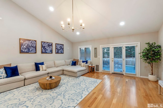 living room featuring high vaulted ceiling, recessed lighting, a notable chandelier, baseboards, and light wood-type flooring