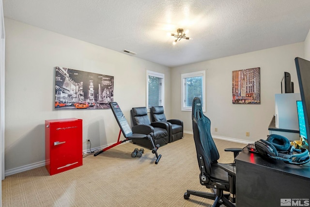 carpeted office space featuring visible vents, a textured ceiling, and baseboards