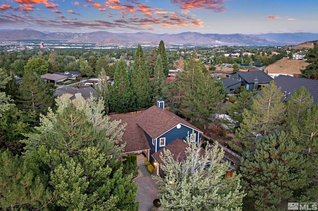 aerial view at dusk featuring a mountain view