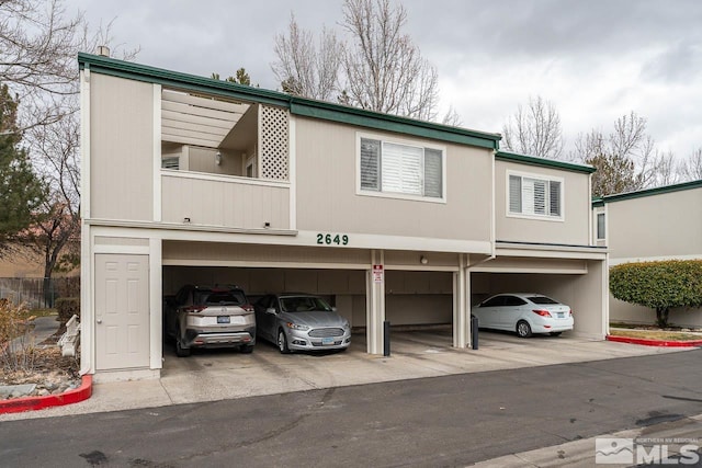 view of front of property featuring covered parking