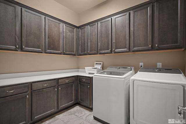 washroom with marble finish floor, cabinet space, and separate washer and dryer