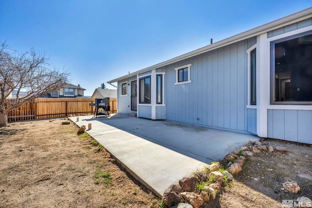 rear view of house featuring a patio area and fence