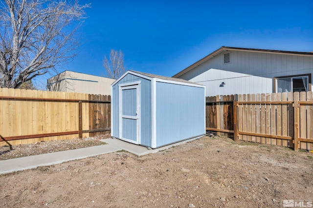 view of shed with a fenced backyard