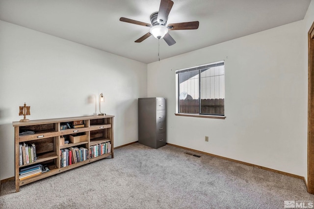 interior space featuring carpet floors, baseboards, visible vents, and ceiling fan