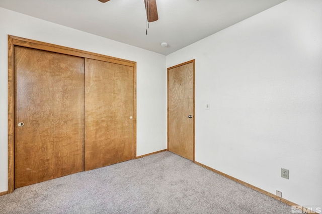 unfurnished bedroom featuring ceiling fan, carpet floors, a closet, and baseboards