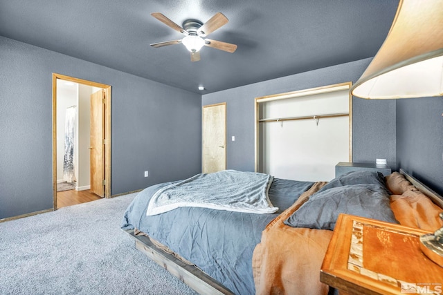 carpeted bedroom with a ceiling fan and baseboards