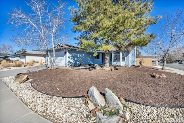 ranch-style home with driveway and an attached garage