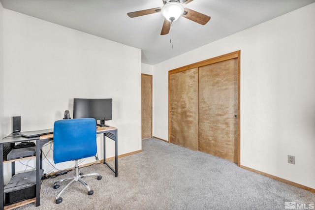 home office featuring carpet floors, a ceiling fan, and baseboards