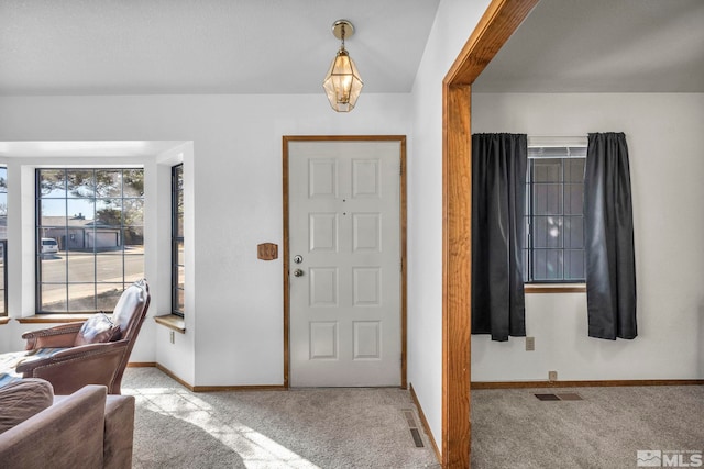 carpeted foyer entrance featuring baseboards and visible vents