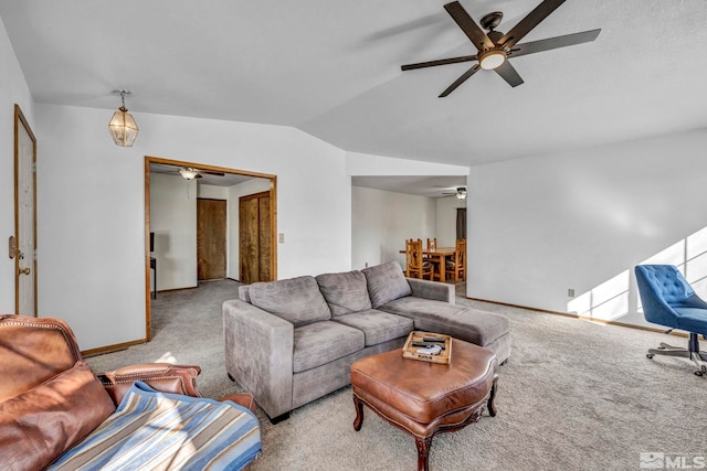 living area with lofted ceiling, baseboards, carpet floors, and a ceiling fan