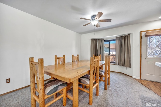 dining area featuring baseboards, a ceiling fan, and a healthy amount of sunlight