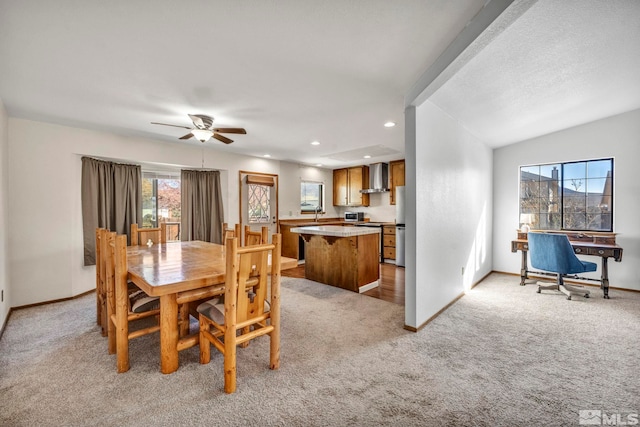 dining room with recessed lighting, light carpet, and baseboards