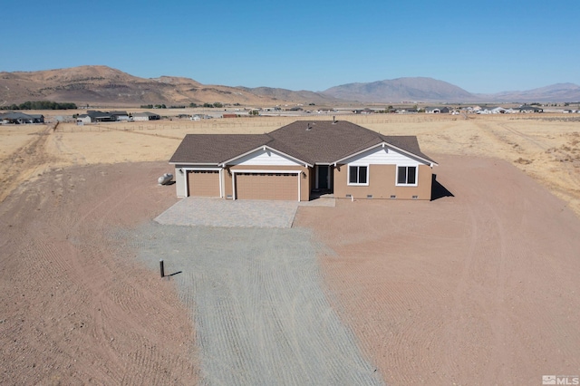 view of front facade with a garage, driveway, and a mountain view