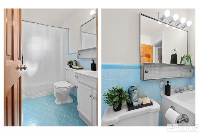 bathroom featuring toilet, a wainscoted wall, a shower with shower curtain, vanity, and tile walls