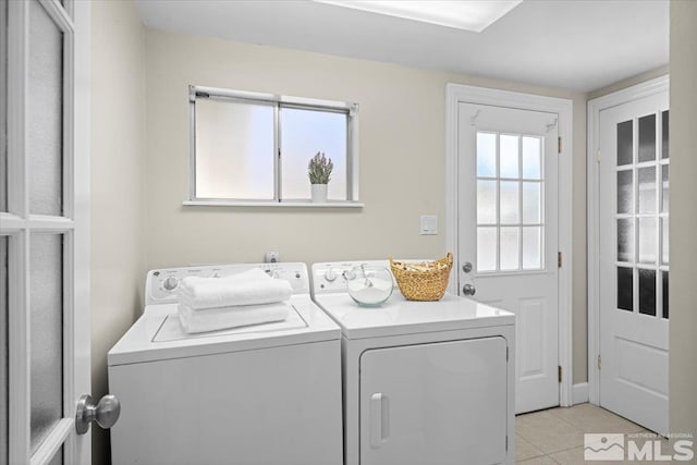 laundry area with laundry area, light tile patterned flooring, and separate washer and dryer