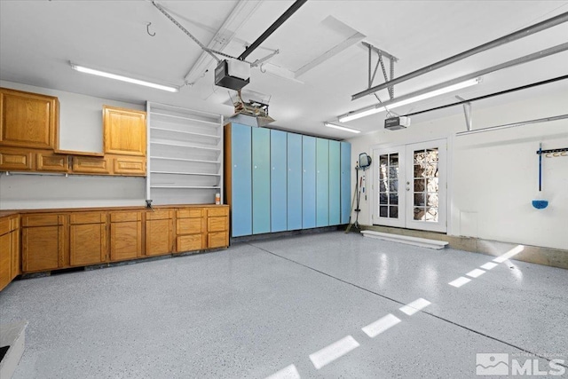 garage featuring a garage door opener and french doors