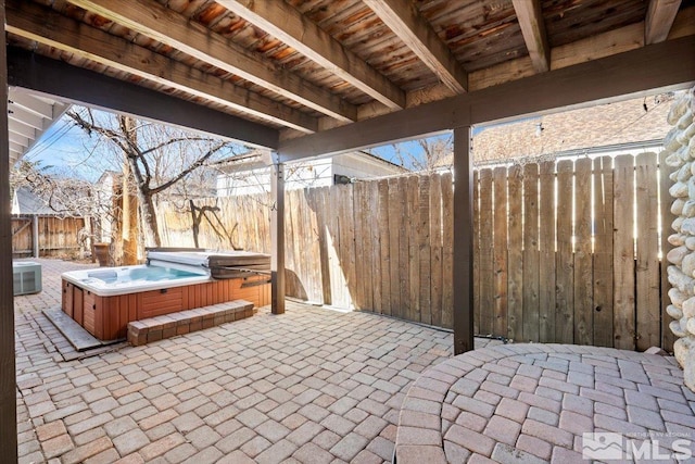 view of patio / terrace with a fenced backyard, cooling unit, and a hot tub