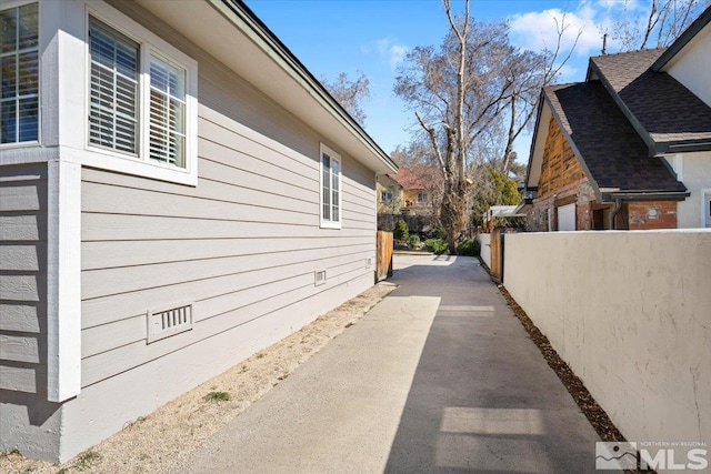 view of property exterior featuring crawl space and fence