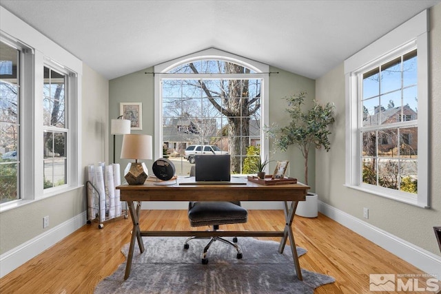 office space featuring light wood-type flooring and a healthy amount of sunlight