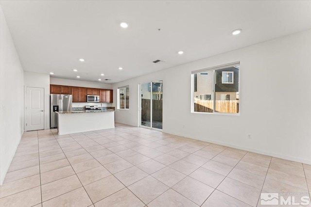 unfurnished living room featuring light tile patterned floors, visible vents, and recessed lighting