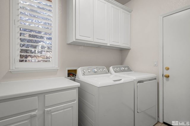 laundry room with cabinet space and washer and clothes dryer