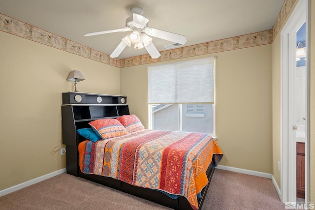 carpeted bedroom with visible vents, baseboards, and multiple windows