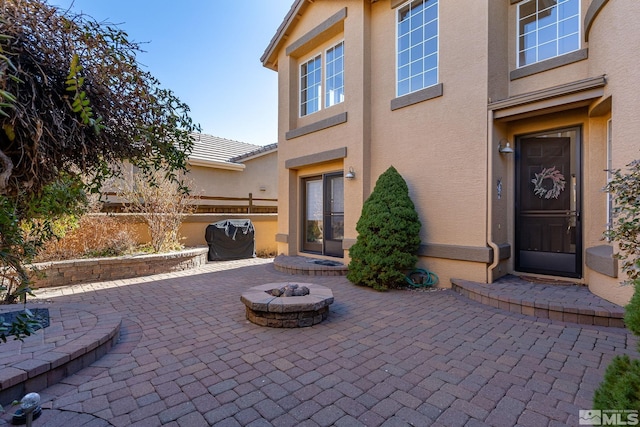 view of patio / terrace featuring a fire pit, fence, and grilling area