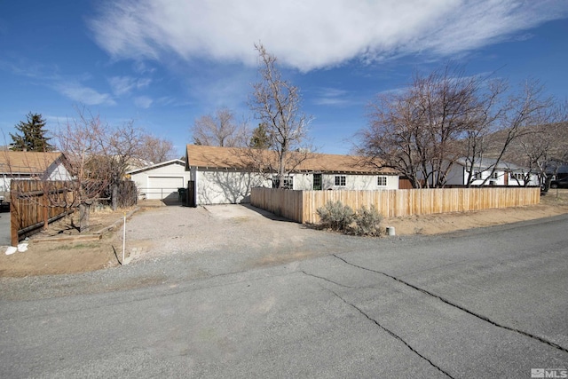 view of front of house featuring a garage and a fenced front yard