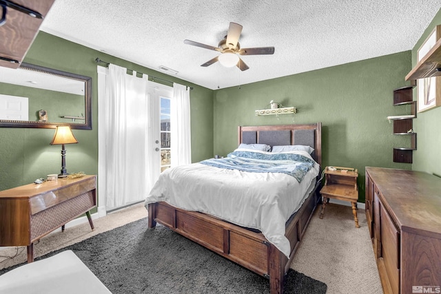 bedroom with carpet floors, visible vents, a ceiling fan, a textured ceiling, and access to outside