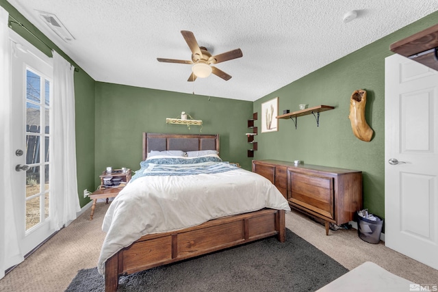 bedroom featuring access to exterior, ceiling fan, multiple windows, and visible vents