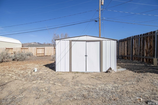 view of shed with a fenced backyard