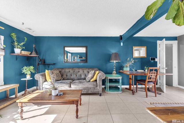 tiled living room featuring baseboards, visible vents, and a textured ceiling