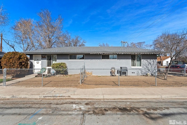 ranch-style home with a fenced front yard and a shingled roof