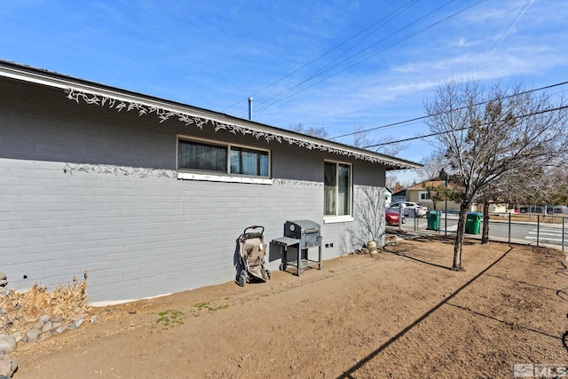 view of side of property featuring fence