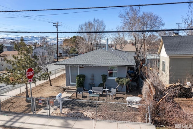 view of front of property featuring a gate, a fenced front yard, a shingled roof, and entry steps