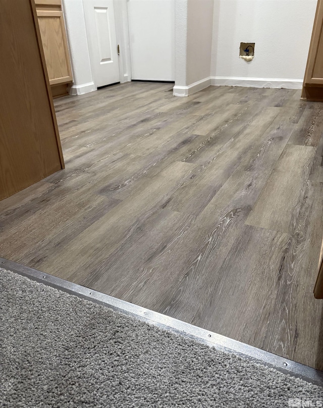 interior details featuring baseboards and wood finished floors