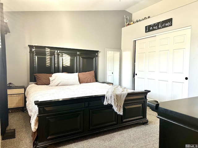 bedroom with a closet, carpet floors, and vaulted ceiling