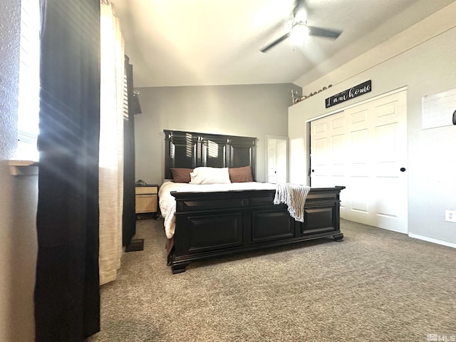 bedroom featuring a closet, lofted ceiling, carpet, and a ceiling fan