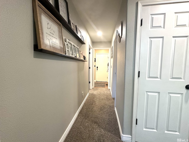 hall with carpet and baseboards