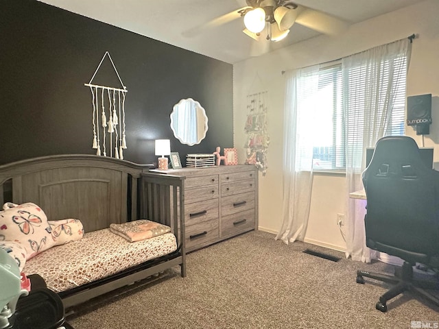 carpeted bedroom featuring visible vents, baseboards, and a ceiling fan