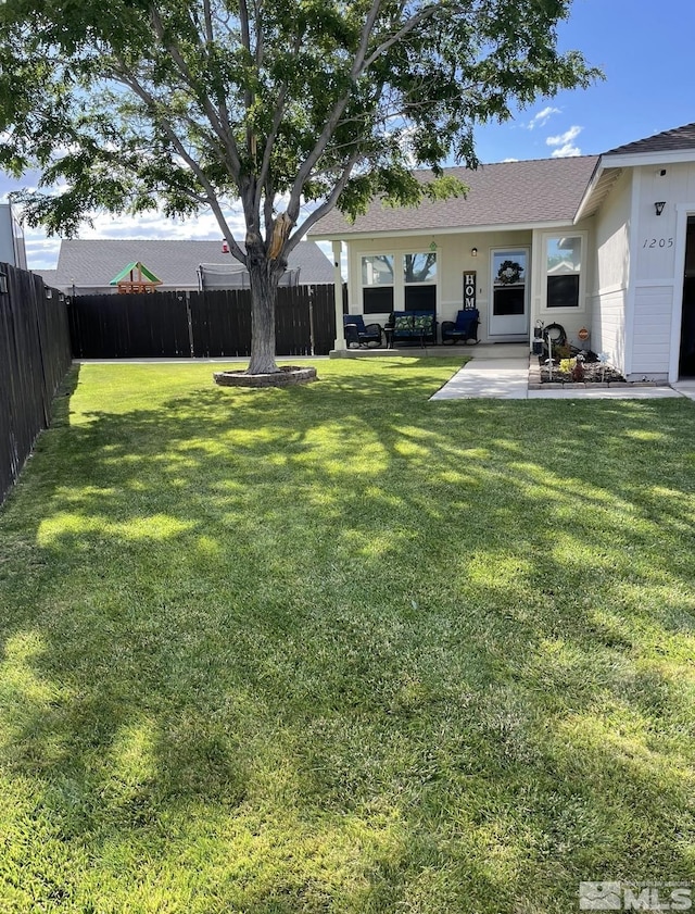 view of yard with a patio and a fenced backyard