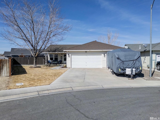 ranch-style home featuring driveway, a shingled roof, an attached garage, and fence